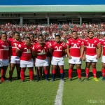 통가에서 열린 스포츠 경기 역사 - **Prompt:** A dynamic, wide-angle shot of a group of powerful Tongan male rugby players performing t...